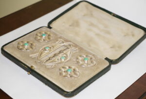 A. E. Jones buckle and buttons set with Ruskin enamels.